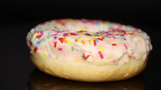 Fresh, sweet donut with icing sprinkled with colorful candy canes