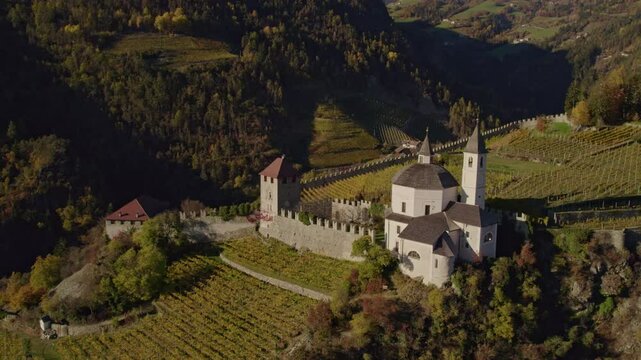Aerial view of Monastero di Sabiona monastery with mountain peaks in autumn, Chiusa, South Tyrol, Italy.