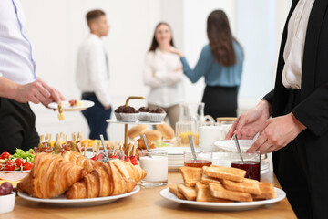 Coworkers having business lunch in restaurant, closeup