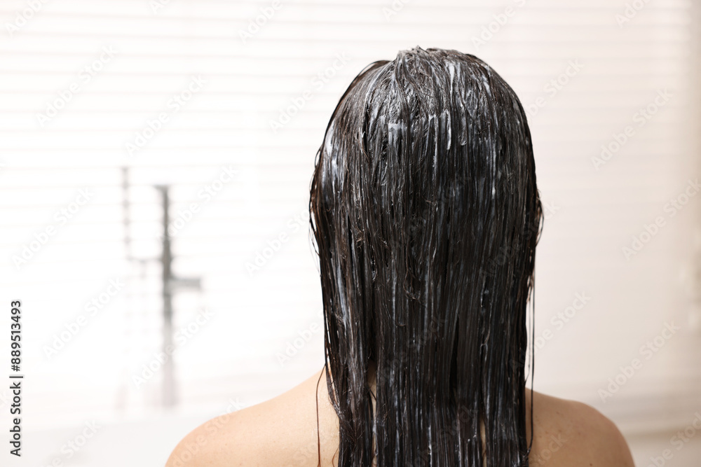 Poster Woman with applied hair mask in bathroom, back view. Space for text