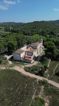 An old modernist farmhouse of stately type isolated with a decoration inspired by the civil gothic. Seen from the air