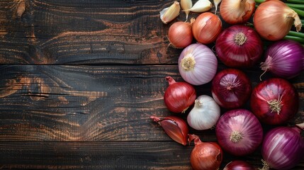 Home grown red onions and garlic on dark wooden background top view