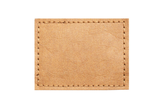 Brown leather belt strap closeup isolated on white. Brown stitched leather seam frame label tag isolated on white. Sewing background. Fabric patch isolated. Perforated leather frame. Brown thread sew.