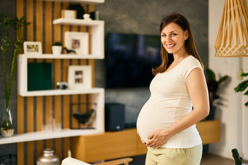 Portrait of a pregnant female, smiling for the camera.