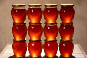 Jars of fresh flower honey on the table