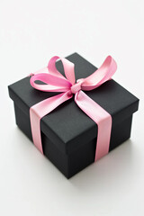 Obraz premium A black gift box with a pink ribbon, symbolizing elegance and surprise, set against a clean white background with ample copy space.