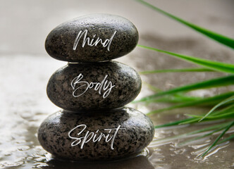 Mind, body and spirit text on zen stones. Spiritual and health concept