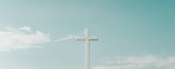A solitary white cross stands tall against a blue sky with scattered clouds, symbolizing faith and serenity. Ideal for religious and spiritual themes.