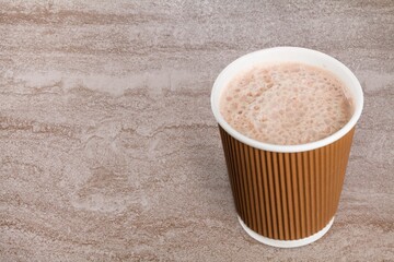 Cup of tasty hot coffee on wooden desk