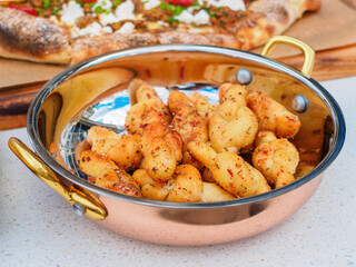 Dough knots with garlic butter in a bowl close-up
