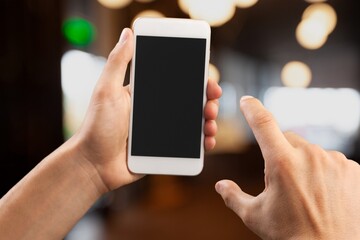 Hand hold a mobile phone on the street