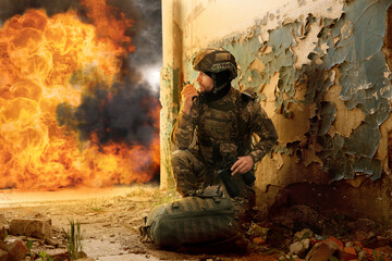 Soldier using radio in destroyed building during military operation