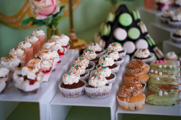 Candy bar at a wedding. Delicious desserts. Beautiful decorations. Fruits. Sweet cakes on your holiday. Birthday. Sweet life. interior photo.