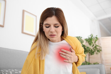 Woman suffering from pain in chest at home. Heart disease