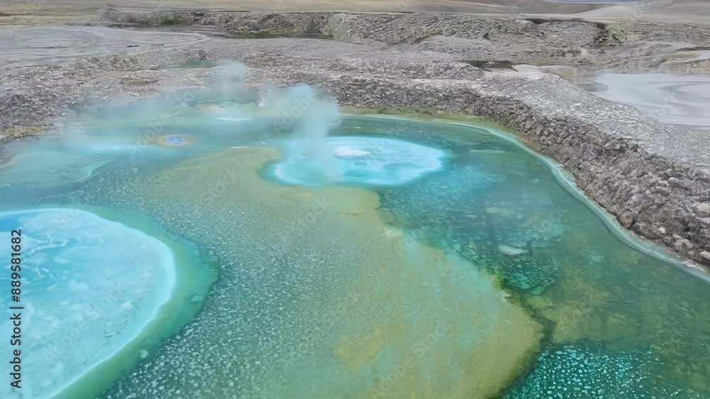 Poster a drone shot swoops down towards the thermal pools revealing the intricate formations of minerals an