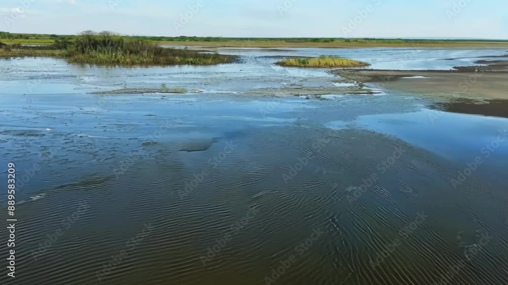 Poster timelapse of the dramatic changes in water level during low and high tide in the estuary showcasing 