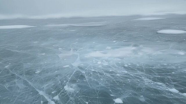 A hush falls over the frozen landscape the only sound is the occasional cracking of ice shifting beneath.