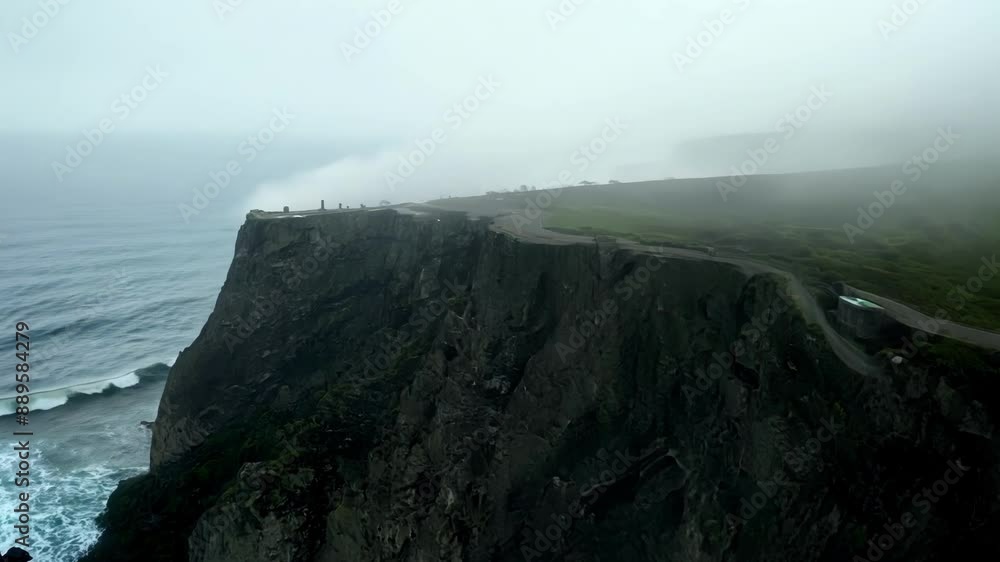 Poster the blurry shape of a towering cliff looms through the fog adding to the eerie atmosphere of the fog