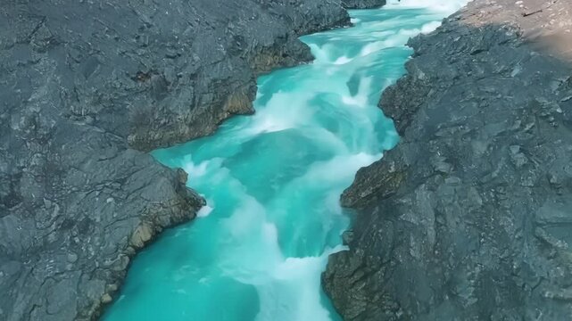 The vibrant blue waters of the glacial meler streams contrast against the grey landscape creating a stunning visual display.