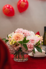 A bouquet of pastel flowers for summer sits in the middle of a table at a Chinese restaurant.