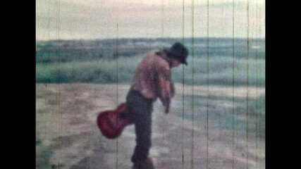 Male actor jumping from house window. Man with guitar, musician performing dangerous trick. Stunt filming of wild west film. stuntman in old western movie. Vintage color archive. Retro cheap cinema