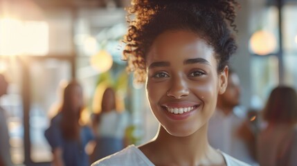 Smiling young woman in casual attire with curly hair in well-lit cafe, people chatting in background. Lifestyle photography, casual portrait, social interaction, modern cafe atmosphere.