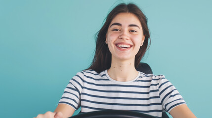 Fototapeta premium portrait of a woman holding a steering wheel in front of blue background