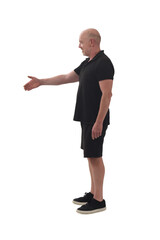 side view of a  man shaking hands with an imaginary person on white background