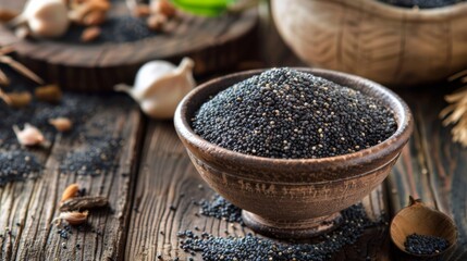 Poppy seeds in small wooden bowl on dark table. Poppies head on board with backlight.