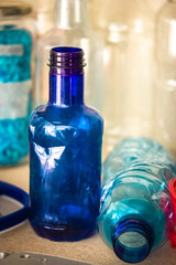 Collection of blue plastic water bottles on blurred background. Recycling plastic to reuse for manufacturing. Zero waste, ecology and planet save. 