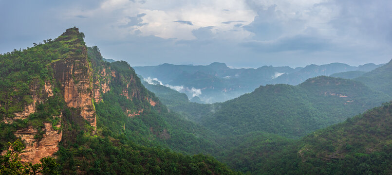 Panoramic view of Pachmarhi valley having clouds and mist shrouded hills rolling on each other from vantage point Priyadarshini Point in Pachmarchi, Madhya Pradesh, India.
