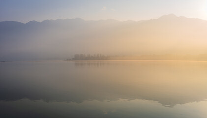 Panoramic landscape of Dal Lake nestled in Himalayas mountain range during sunrise on autumn morning from lake view point at Srinagar, Jammu and Kashmir, India.
