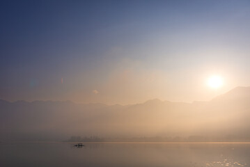 Panoramic landscape of Dal Lake nestled in Himalayas mountain range during sunrise on autumn morning from lake view point at Srinagar, Jammu and Kashmir, India.