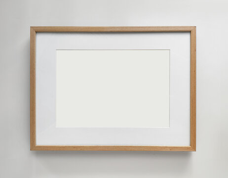 Wooden photo frame A4 size with White Photo Mat, horizontal artwork on a white wall, front view