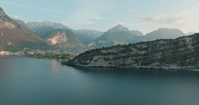 Aerial view of the landscape of Lake Garda in the Dolomite Alps of Italy. The landscape of the coast and mountain peaks of the mountain ranges of the tourist city. High quality 4k footage