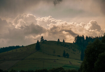 Horizontal shot of a brilliant mountain sunrise with a black foreground and copy space.