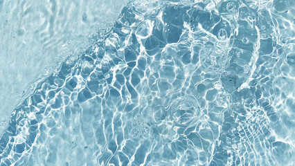 Aqua  liquid colored clear water surface texture with splashes bubbles with copy space. Water waves in sunlight background.
