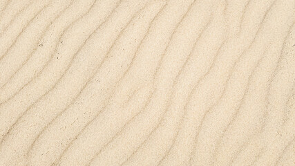 Close-up of wavy detailed sand texture, perfect for summer beach holiday backgrounds or desert-related concepts