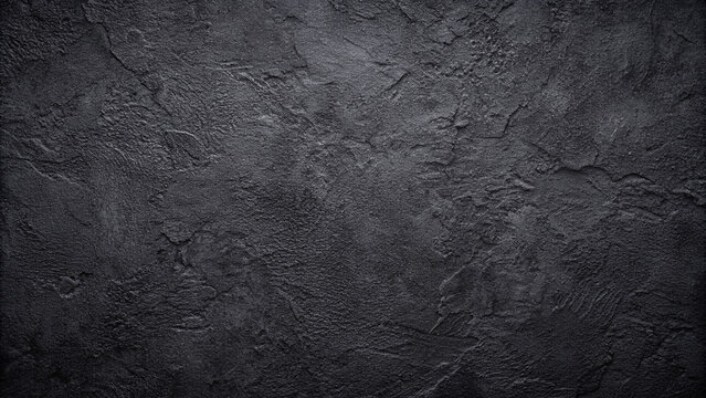Dark black concrete texture with a natural pattern for display or product montage on a copy space image.