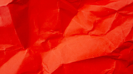 Abstract red crumpled paper texture background, perfect for Christmas or Valentine's Day themed designs and greetings