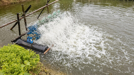A close-up of an aeration pump in a fish farm pond to improve water quality and oxygenation