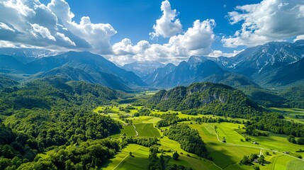 Idyllic green valley with the KamnikSavinja Alps in the background Summer Alpine landscape of the Ravenska Kocna Valley in Zgornje Jezersko Slovenia Aerial view of this beautiful