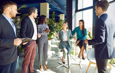 Businesswoman conducting a team meeting or work presentation for a group of colleagues in the...