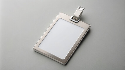 Simple, modern badge holder with a sleek, silver design and a blank, white insert, set against a crisp, clean, light gray background for easy editing.