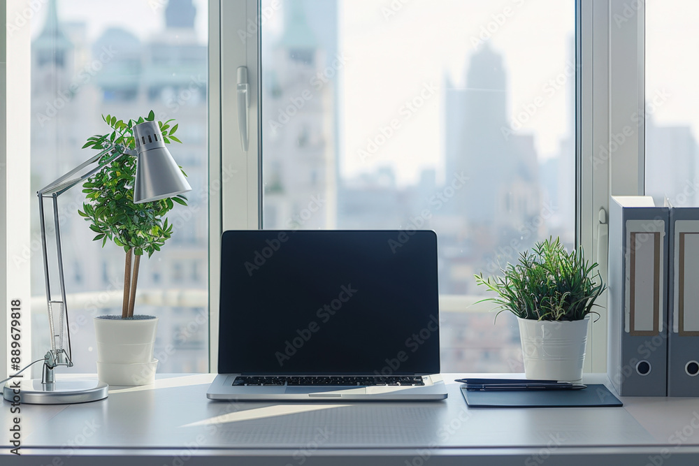 Poster clean and organized workspace is set up on a desk by the window, bathed in natural light and offerin