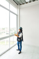 Engineer latin woman in safety equipment. Building, developing, construction and architecture concept.