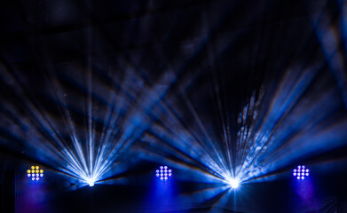 Blue light beams on black background