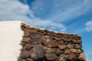 Detail of a white and stone wall, La Graciosa, Spain