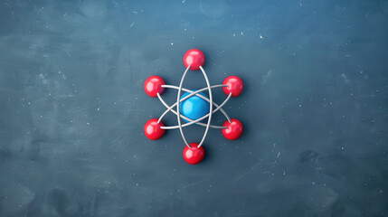 3D model of an atom with red electrons orbiting a blue nucleus, representing science and atomic structure, on a dark chalkboard background.