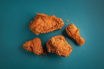 Fried Chicken breast hot crispy strips crunchy chicken tenders three pieces isolated on color background